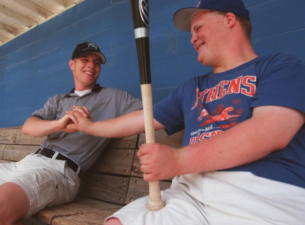Ashley Pittman, right, the one-time manager for the Athens Drive baseball team, thanks Josh Hamilton for an autographed bat he presented to Pittman.