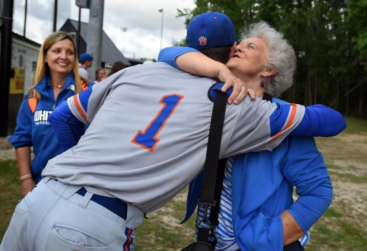 MacKenzie Gore gives his grandmother, Janice Gore, a hug as his mother Selena Gore looks on. Gore, a projected top five pick in the Major Leauge Baseball draft, had just pitched his team to a 19-0 win over Fairmont High School in Fairmont, N.C., Thursday, May 4, 2017.