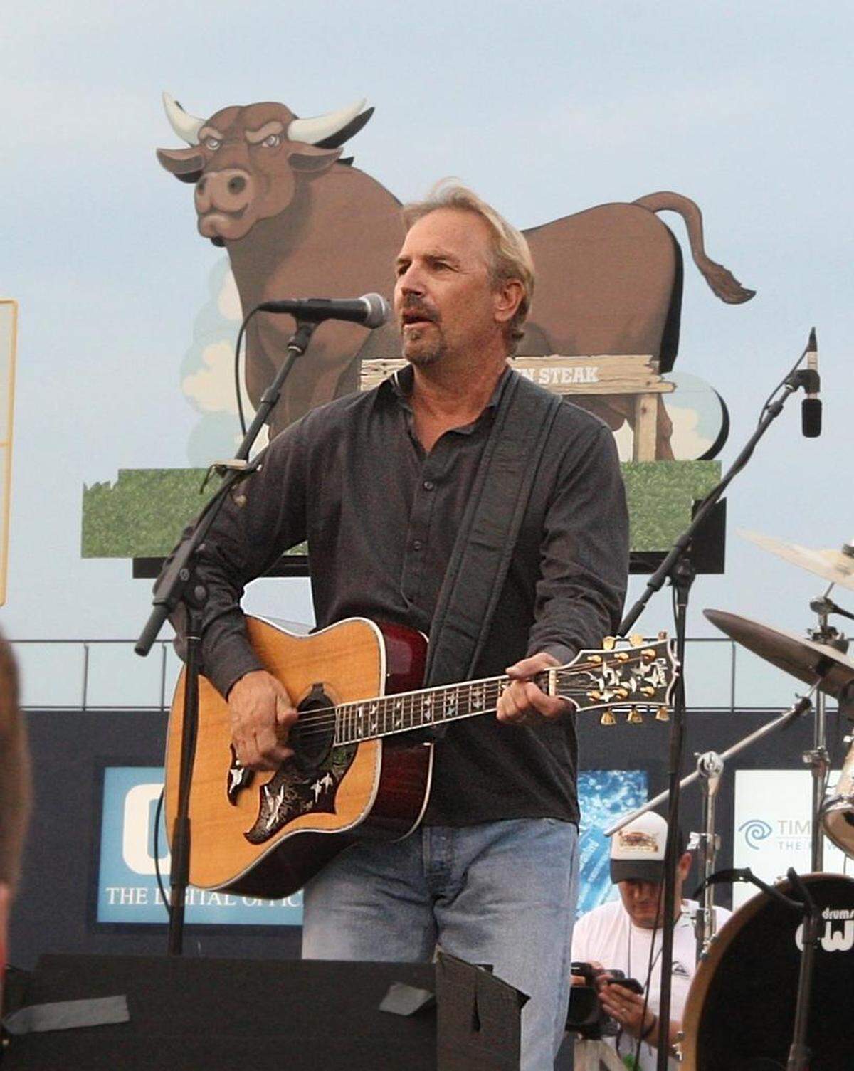 Actor Kevin Costner sings to the estimated 7000 fans for his Independence Day concert at the Durham Bull Athletic Park. Costner and his band are celebrating the 20th anniversary of the movie Bull Durham.