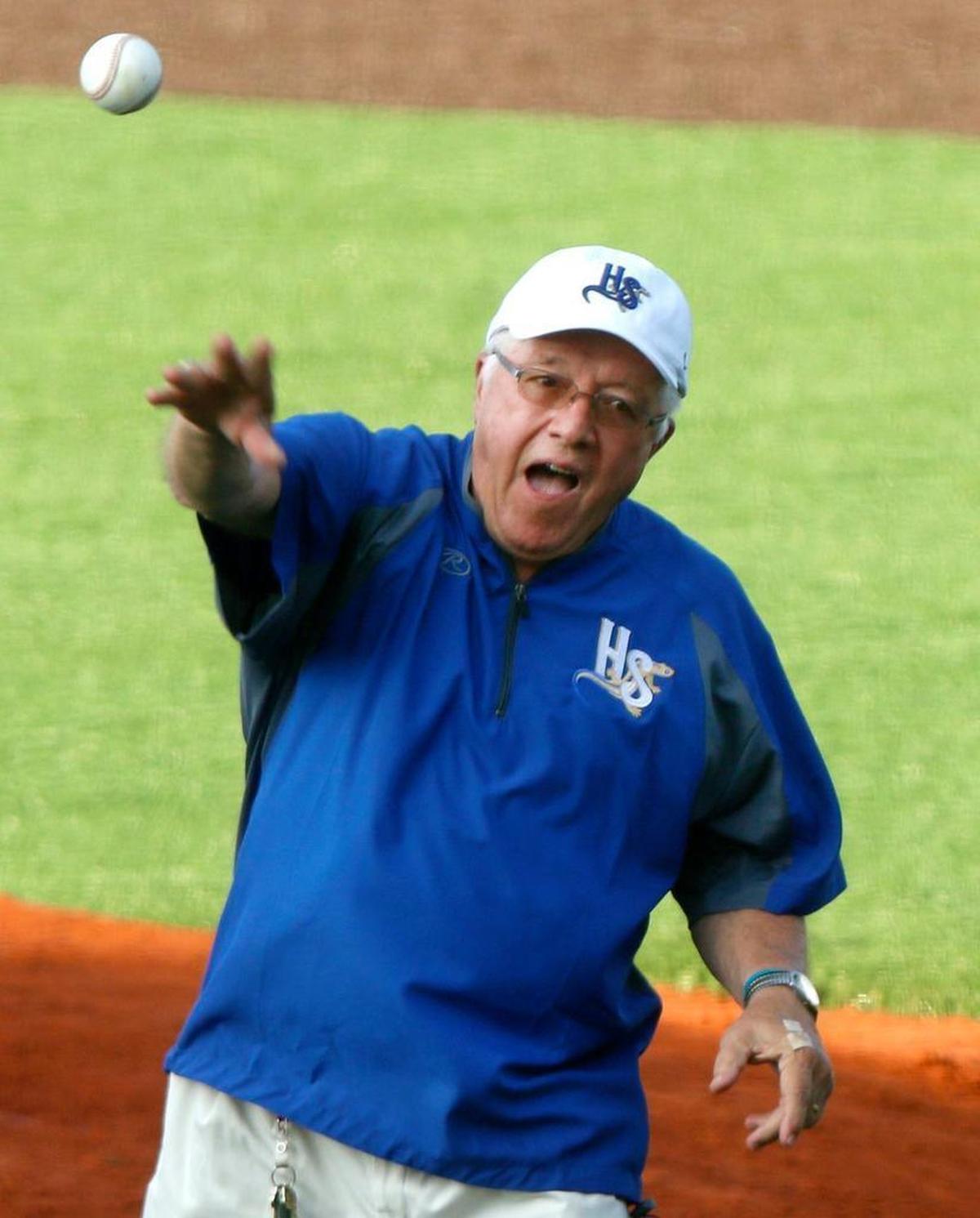 Holly Springs Mayor Dick Sears throws a pitch at opening night Thursday for the Holly Springs Salamanders.