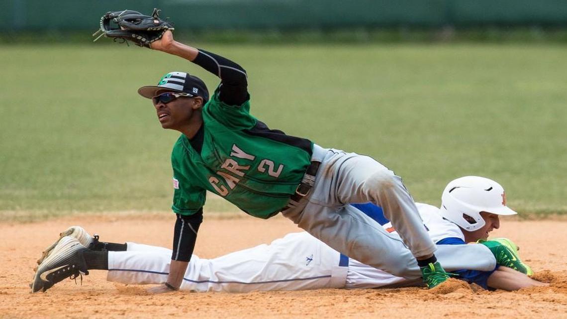 Cary's Greg Jones, seen here showing the ball to an umpire after tagging out Athens Drive's Sam Enders in March, is the first player drafted straight out of Cary High School since 1999.