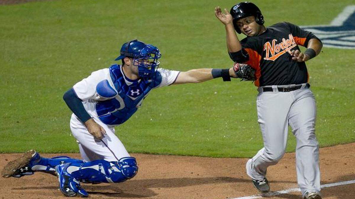
Norfolk’s Audry Perez (24) is tagged out at home by Durham Bulls catcher Curt Casali (19) on a throw from centerfield, following a base hit by Henry Urrutia in the third inning of the Bulls’ season home opener on Wednesday, April 15, 2015 a the Durham Bulls Athletic Park in Durham, N.C. Perez was caught after trying to advance to home from second base.
