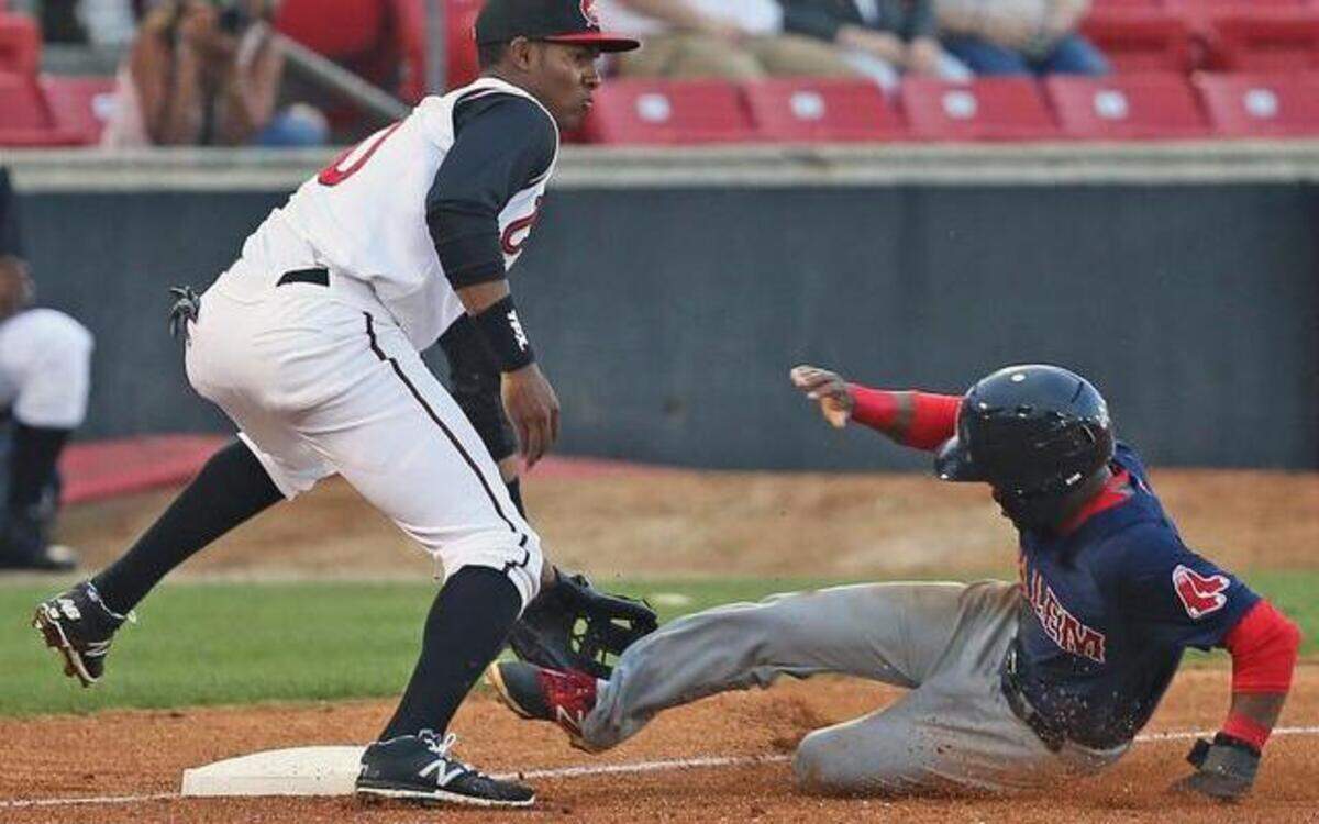 
Salem baserunner Manuel Margot, right, beats the throw to Carolina third baseman Carlos Franco during the seaon opener for the Mudcats at Five County Stadium. The Red Sox won 2-0 the game was called after seven innings due to rain.



