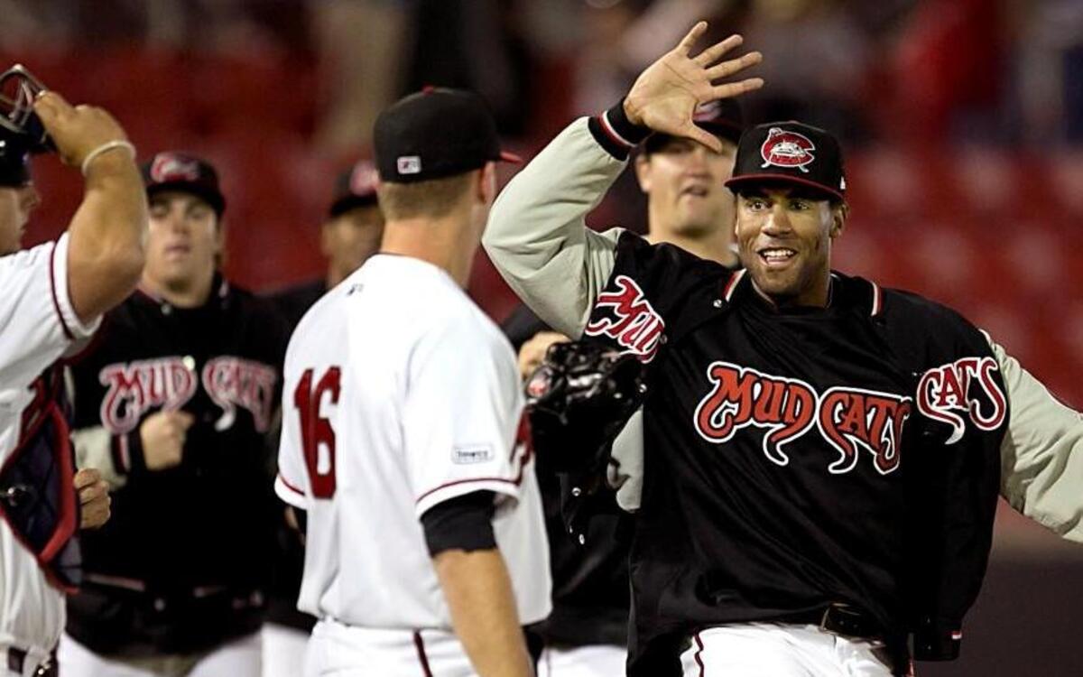 Carolina Mudcats pitcher Zach Byrd (25) congratulates fellow pitcher Evan Phillips (16) after he struck out Myrtle Beach’s Yasiel Balaguert in the ninth inning to secure the Mudcats’ 3-2 victory in their home opener on Thursday April 14, 2016 at Five County Stadium in Zebulon, N.C.