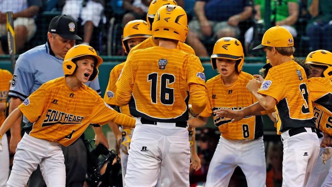 Greenville, N.C.'s Carson Hardee (16) is greeted by teammates after hitting a solo home run off Lufkin, Texas, pitcher Hunter Ditsworth during the first inning.