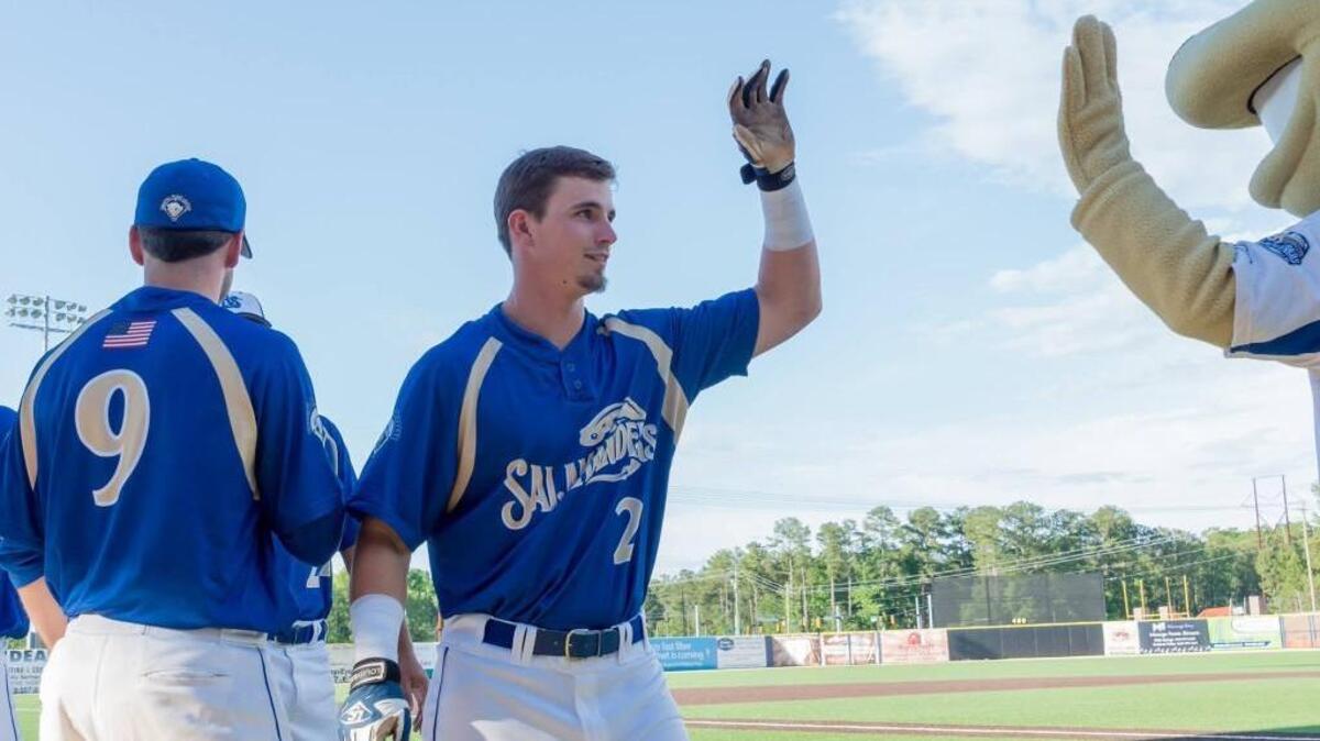 Dillon Stewart, the only All-Star for Holly Springs this season, slaps fives with Sal the Salamander.
