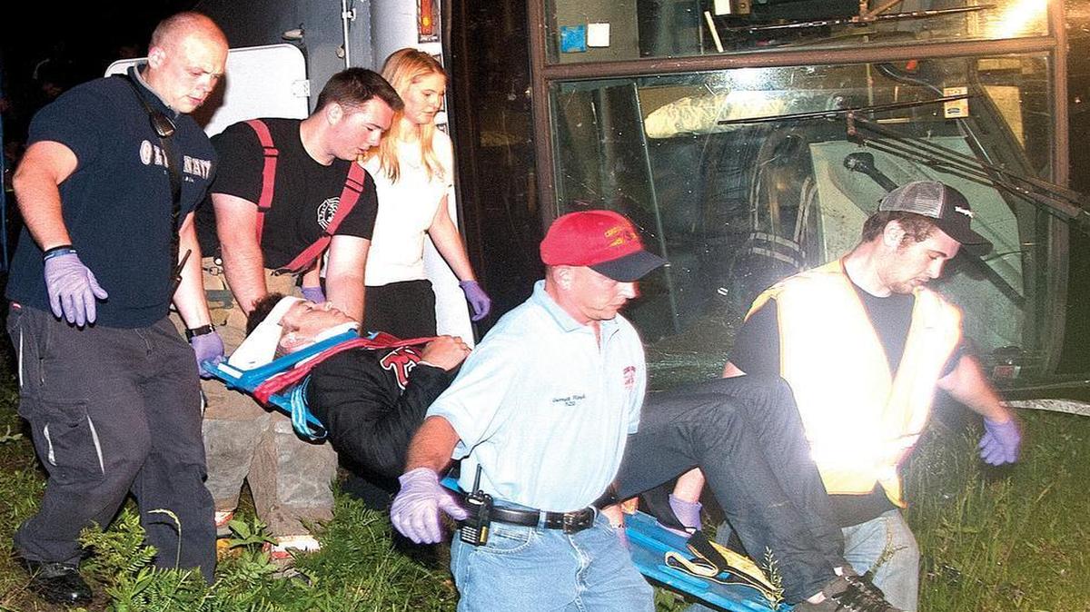 
Chadbourn-Klondyke Fire & Rescue personnel carry an injured passenger from a charter bus to an ambulance. There were 30 to 35 people on board and eight or nine taken to Columbus Regional Medical Center with non-life threatening injuries. 
