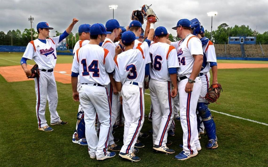 MacKenzie Gore (left) stands to the side as the Wolfpack baseball team readies for their last home game of the 2017 seaon in Whiteville, N.C., Saturday, May 13, 2017.