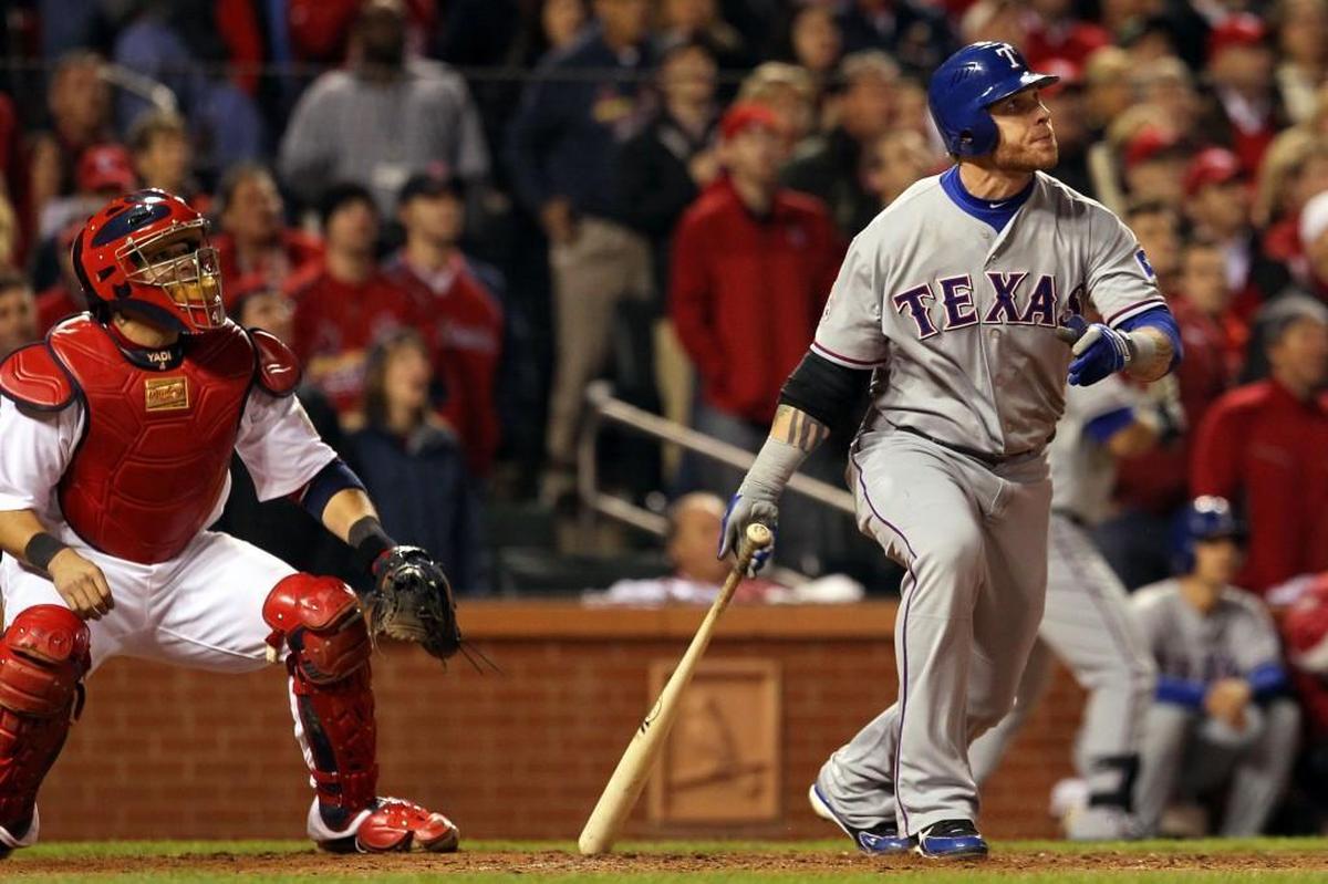 The Rangers’ Josh Hamilton hits a two-run home run in the 10th inning during Game Six of the World Series against the Cardinals in 2011.