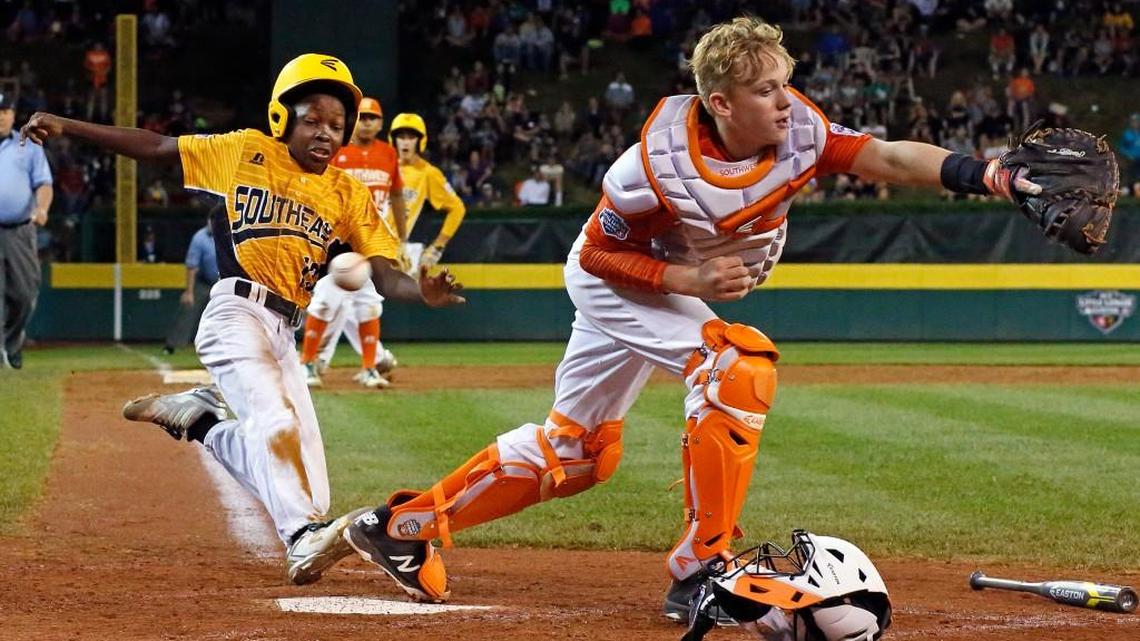 Lufkin, Texas catcher Chandler Spencer, right, can’t handle the throw from first baseman Mark Requena, allowing Greenville’s Cash Daniels-Moye to score on a walk-off fielder’s choice by Thomas Barrett in the seventh inning on Wednesday. Greenville won 2-1.