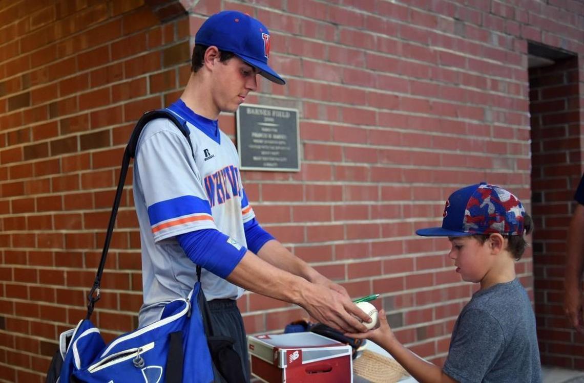 Whiteville's MacKenzie Gore signs a basball for Riverside High School fan Easton Warren after the Wolfpack defeated Williamston during the NCHSAA 1A playoff game in Williamston, N.C. Wednesday, May 16, 2017.