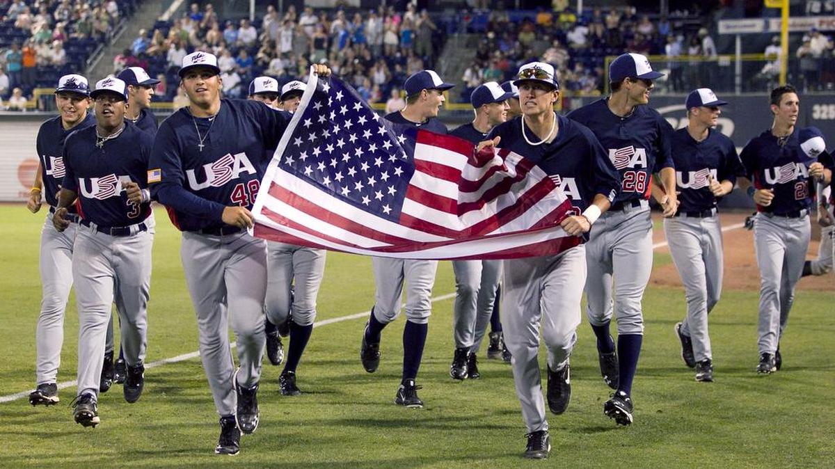 Team USA’s Dominic Ficociello (32) and D.J. Baxendale (48) carry the American Flag with the teammates in a celebratory lap around the Durham Bulls Athletic Park following their 4-3 victory over the Japan National Baseball Team on Tuesday July 5, 2011 at Durham Bulls Athletic Park in Durham, N.C.
