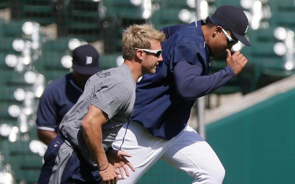 Detroit Tigers first baseman Miguel Cabrera runs sprints with Detroit Tigers assistant strength and Conditioning Coordinator Kyle Bergman during batting practice before a baseball game between the Detroit Tigers and the Kansas City Royals, Tuesday, Aug. 4, 2015, in Detroit. (AP Photo/Carlos Osorio)