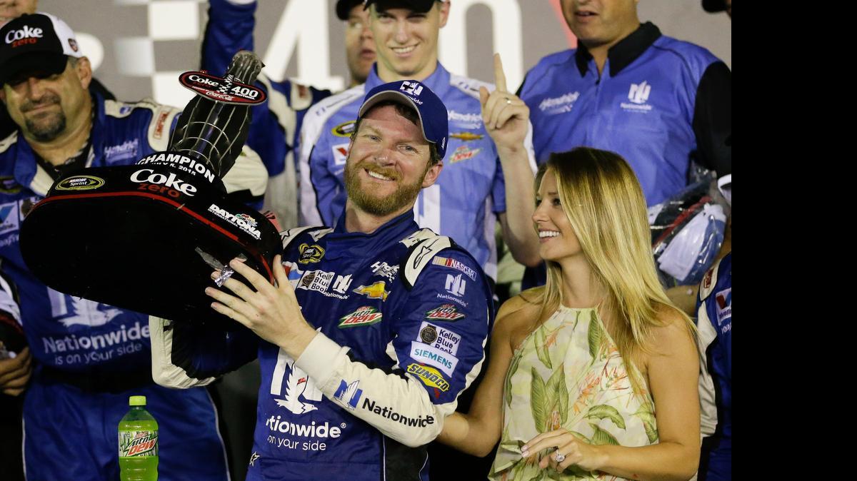 
Dale Earnhardt Jr. and fiance Amy Reimann, right, celebrate after Earnhardt won the NASCAR Sprint Cup series Coke Zero 400 at Daytona International Speedway early Monday morning. 
