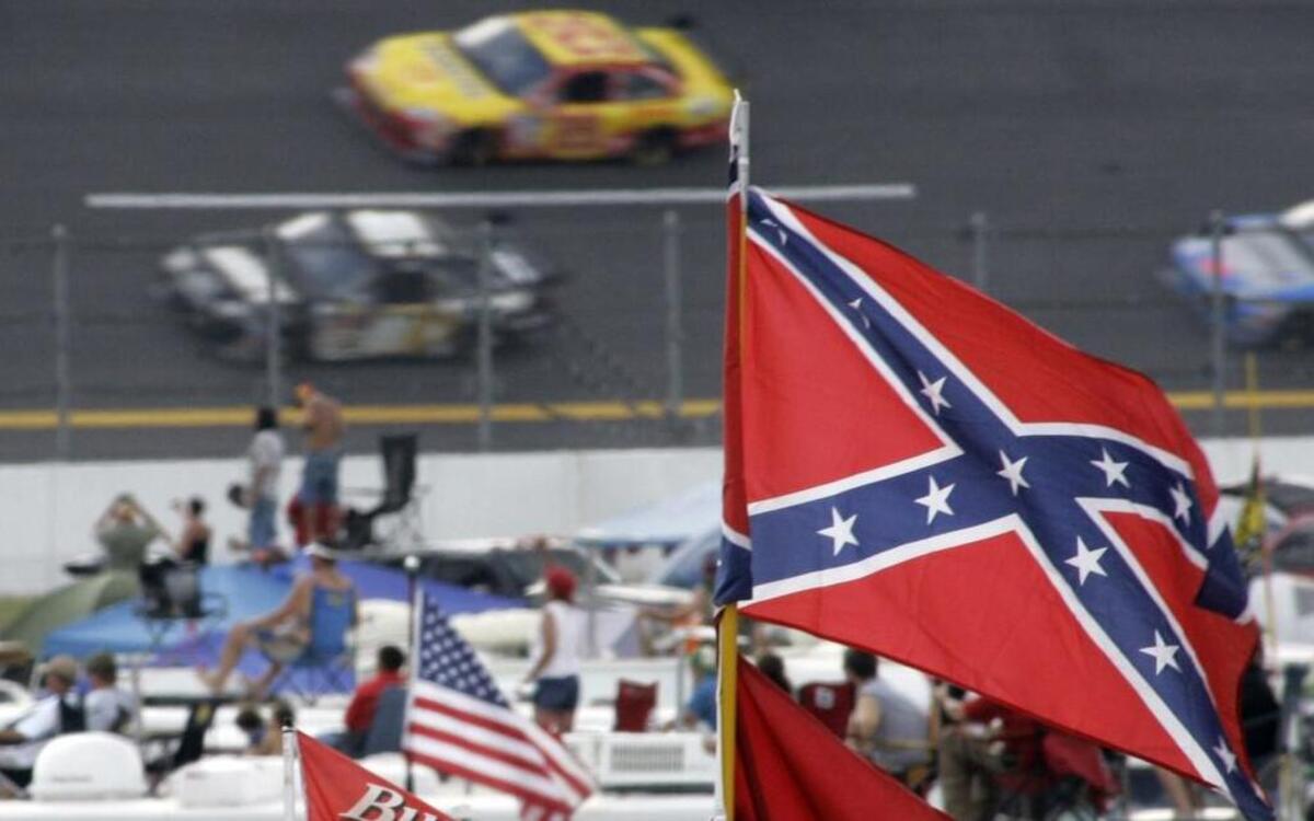 
In this Oct. 7, 2007, file photo, a Confederate flags fly in the infield as cars come out of turn one during a NASCAR auto race at Talladega Superspeedway in Talladega, Ala. NASCAR is backing South Carolina Gov. Nikki Haley's call to remove the Confederate flag from the South Carolina Statehouse grounds in the wake of a massacre at a Charleston church, it said in a statement Tuesday, June 23, 2015. Though NASCAR bars the use of the flag in any official capacity, many fans fly the flag at their races. 

