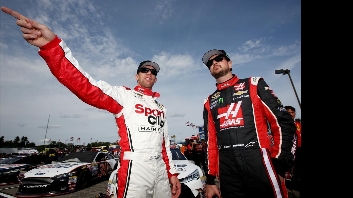 
 Carl Edwards and Kurt Busch stand on the grid during Friday’s qualifying for the NASCAR Sprint Cup Series 5-Hour Energy 301 at New Hampshire Motor Speedway on July 17, 2015 in Loudon, N.H. Edwards will start from the pole Sunday.
