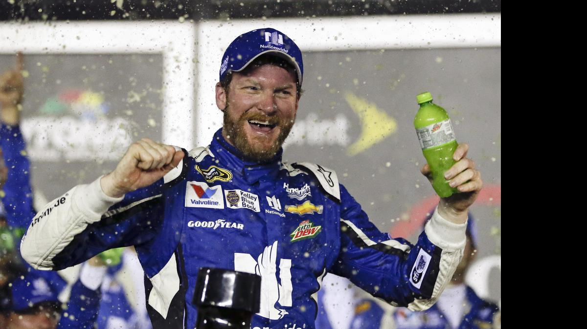 
Dale Earnhardt Jr. celebrates in Victory Lane after winning the NASCAR Sprint Cup series race at Daytona International Speedway early Monday.
