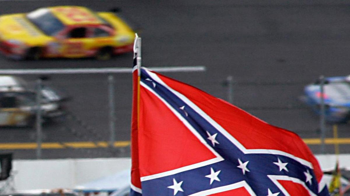 
A Confederate flags fly in the infield as cars come out of turn one during a NASCAR auto race at Talladega Superspeedway in Talladega, Ala. NASCAR is backing South Carolina Gov. Nikki Haley's call to remove the Confederate flag from the South Carolina Statehouse grounds in the wake of a massacre at a Charleston church, it said in a statement Tuesday, June 23, 2015. Though NASCAR bars the use of the flag in any official capacity, many fans fly the flag at their races.

