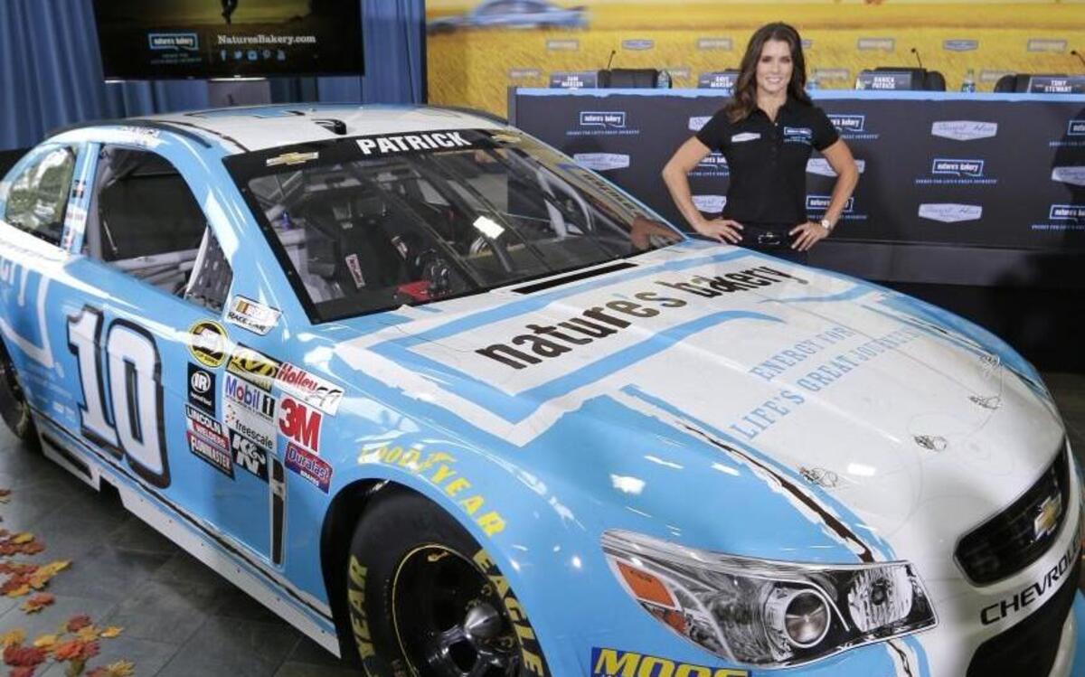 
Danica Patrick poses by her new race car during a news conference to announce a new sponsorship for her NASCAR auto racing team at Stewart-Haas Racing's headquarters in Kannapolis. 
