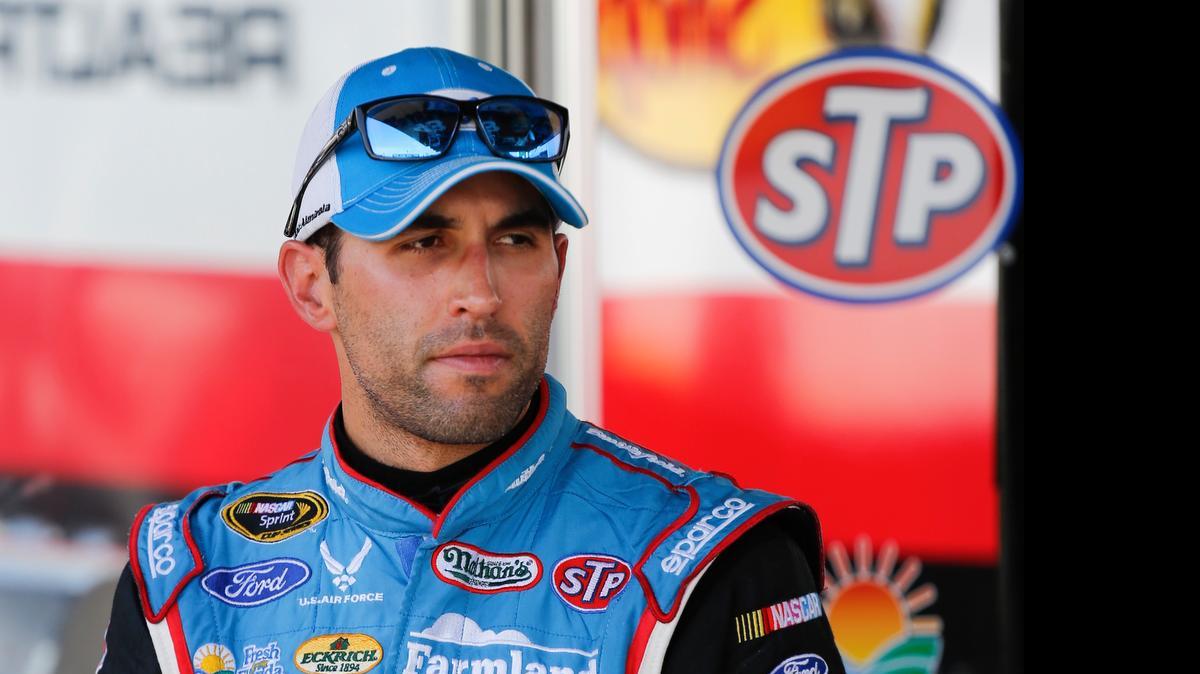 
Aric Almirola stands in a garage during a NASCAR Sprint Cup practice session at Daytona International Speedway, Friday, July 3, 2015, in Daytona Beach, Fla. 
