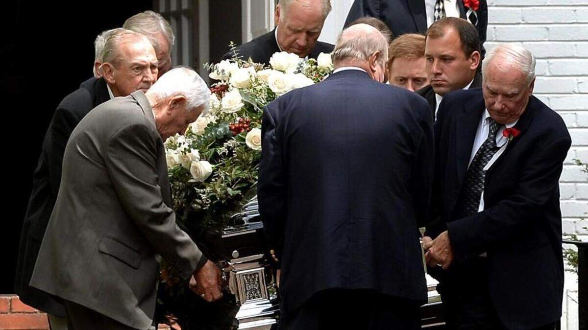
Pallbearers carry the casket of former NASCAR driver and television commentator Buddy Baker from Avondale Presbyterian Church in Charlotte Tuesday afternoon. Baker died Aug. 10 from inoperable lung cancer. Among the pallbearers were NASCAR Sprint Cup Series driver Ryan Newman, right, looking toward flowers, and former Charlotte Observer motorsports writer Tom Higgins, second from left. At top right is former NASCAR driver Bobby Allison.
