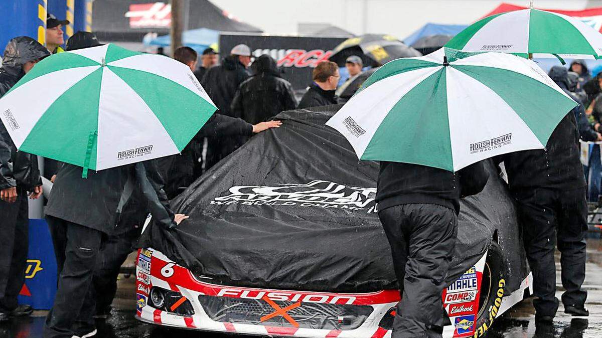 
The crew for Trevor Bayne (6) pushes his car to the inspection station as rain falls at Richmond International Raceway in Richmond, Va., Saturday, April 25, 2015. The NASCAR Sprint Cup series races was postponed until Sunday. (AP Photo/Steve Helber)

