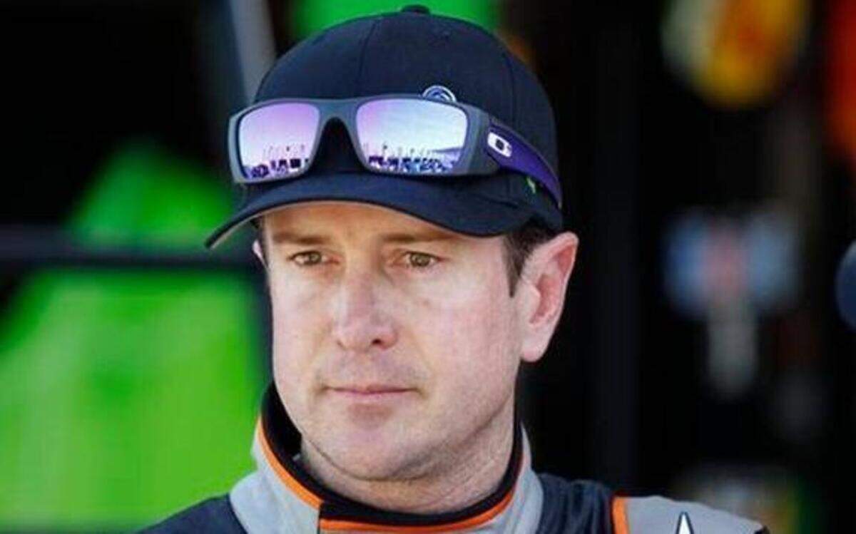 
In this Oct. 9, 2014, file photo, Kurt Busch looks from the garage after practice for the NASCAR Bank of America Sprint Cup series auto race at Charlotte Motor Speedway in Concord, N.C. NASCAR lifted its suspension of Kurt Busch on Wednesday, March 11, 2015, and ruled the former champion can compete in the title Chase should he qualify. Busch missed the first three races of the season when NASCAR suspended him for an alleged domestic assault on his ex-girlfriend.

