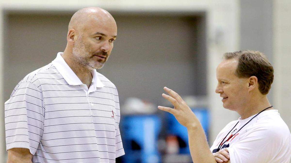 
Atlanta Hawks head coach Mike Budenholzer, right, talks to general manager Danny Ferry in 2013. 

