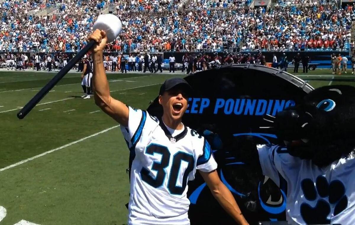 NBA Champion and MVP Stephen Curry rallies Carolina Panthers fans after hitting the Keep Pounding drum prior to the game against the Houston Texans at Bank of America Stadium on Sept. 20, 2015.