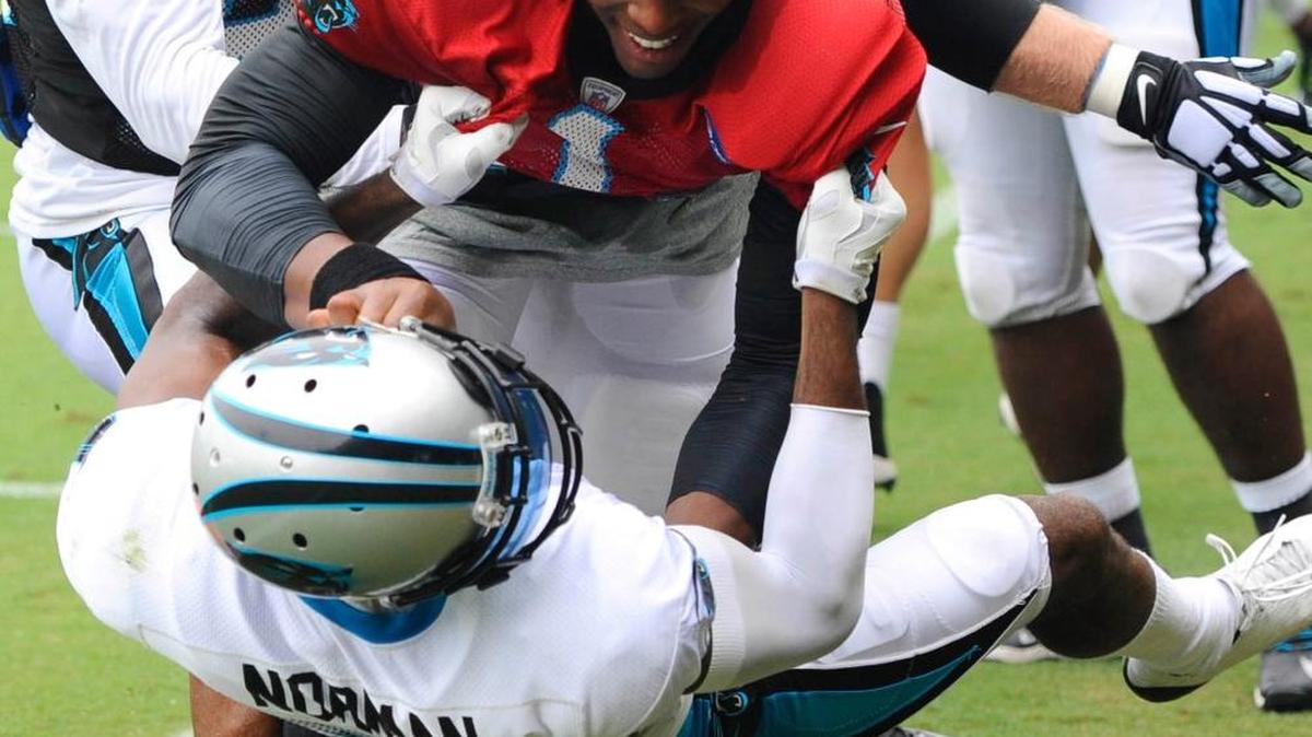
Carolina Panthers’ Cam Newton, top, and Josh Norman skirmish Aug. 10 during training camp.

