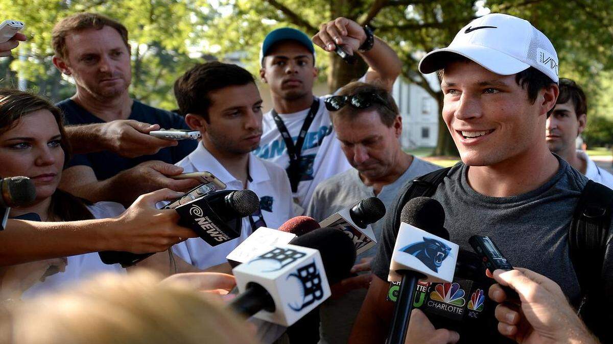 
Carolina Panthers linebacker Luke Kuechly, right, speaks with the media after exiting the team's dorm on the campus of Wofford College in Spartanburg, SC on Thursday, July 30, 2015. 
