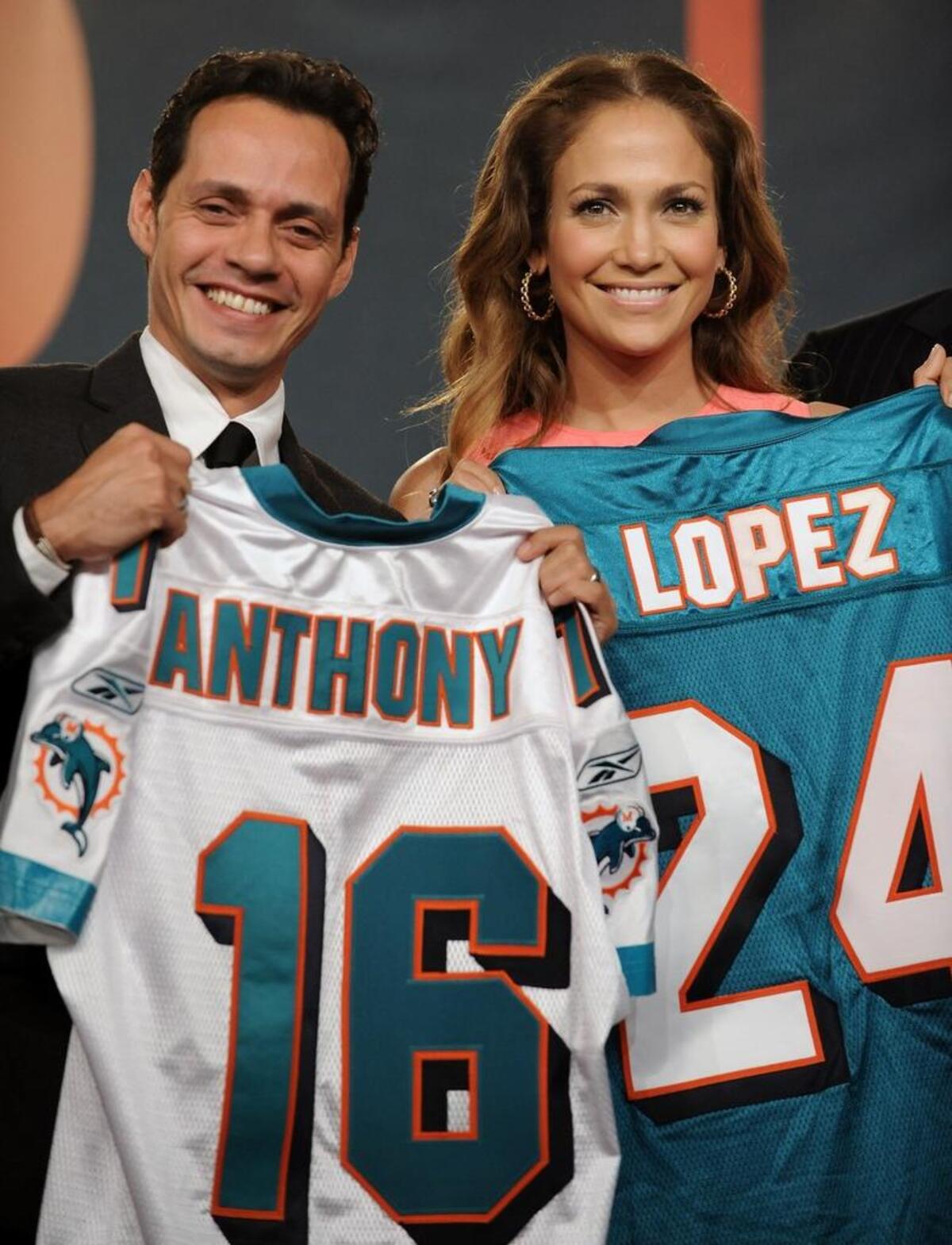 Singer Marc Anthony and actress-singer Jennifer Lopez, then married to Anthony, hold Miami Dolphins jerseys Tuesday, July 21, 2009, as Anthony’s minority ownership in the team is announced.