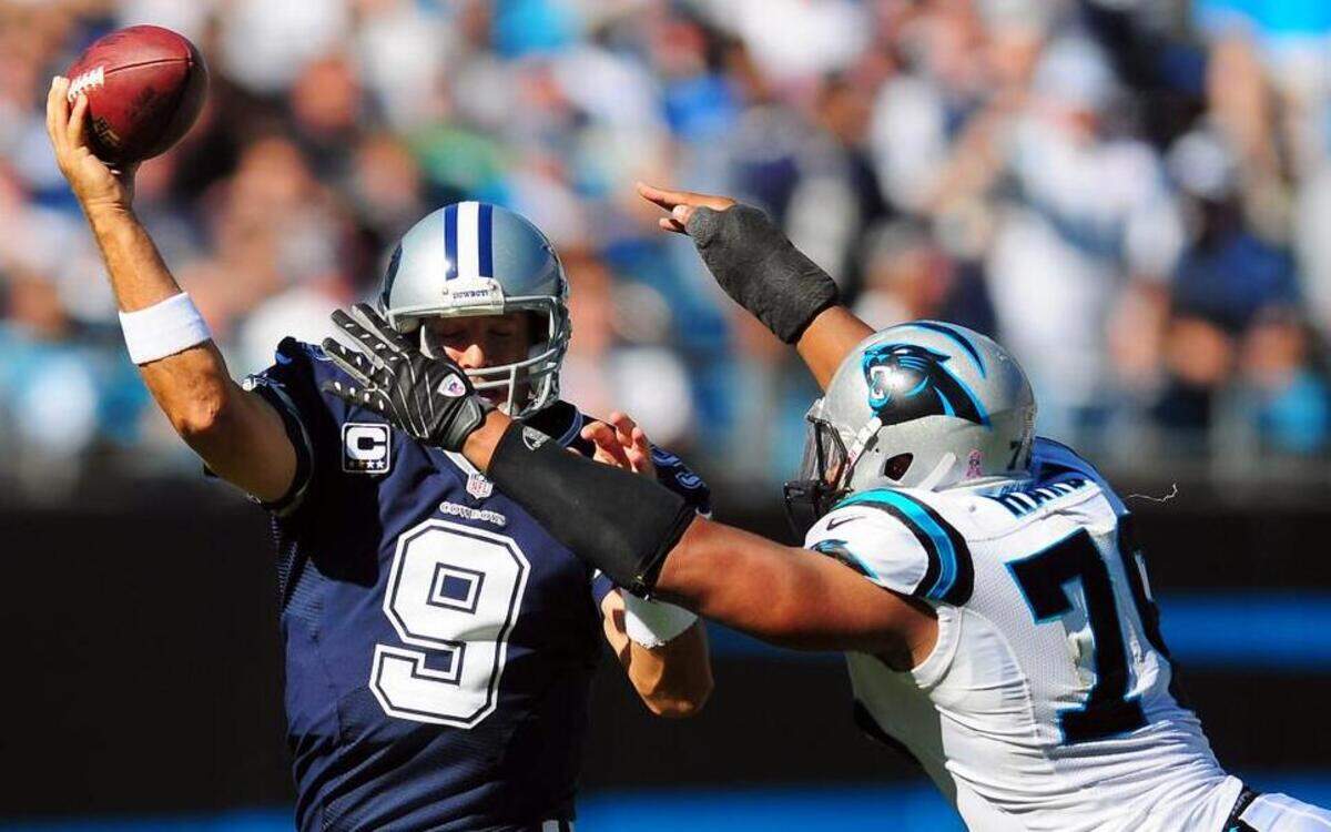 
Dallas Cowboys quarterback Tony Romo hurries to get a pass off as Carolina Panthers defensive end Greg Hardy applies during the game at Bank of America Stadium in 2012. The have a Thanksgiving date with both since Hardy joined the Cowboys in the offseason.
