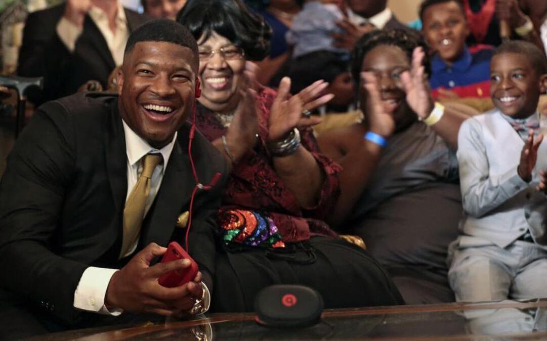 
Jameis Winston reacts with his family and friends as he takes the call from the Tampa Bay Buccaneers that they are selecting him as the number one draft pick, Thursday, April 30, 2015, in Bessemer, Ala. 
