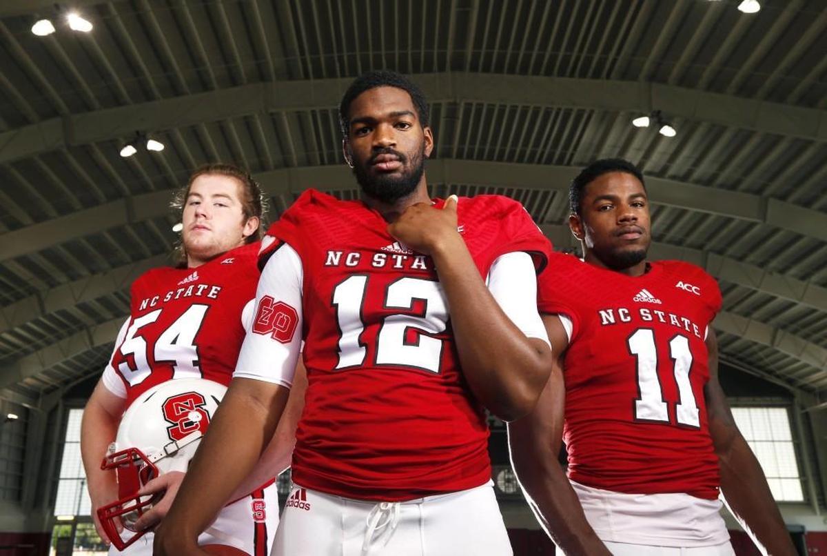 From left, N.C. State’s Joe Thuney, Jacoby Brissett, and Juston Burris were all selected in the 2016 NFL Draft. Thuney and Brissett were picked by the New England Patriots, Burris was selected by the New York Jets.