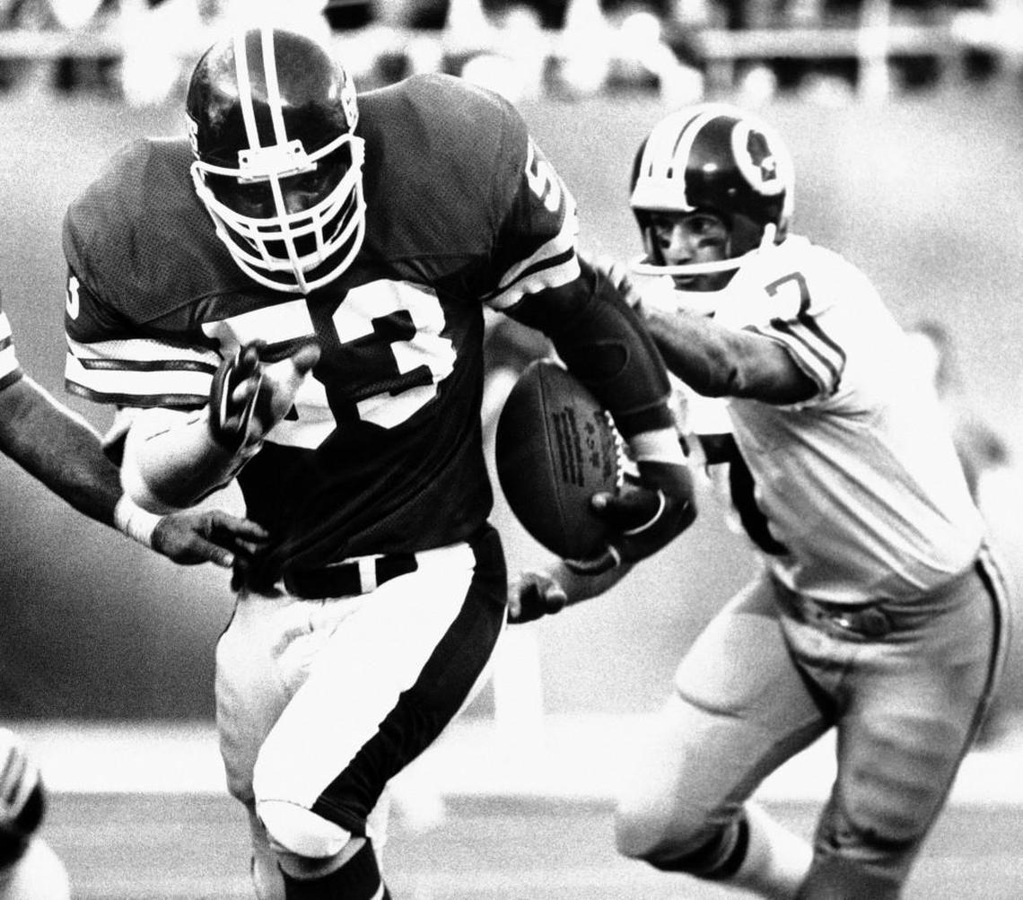 Harry Carson of the New York Giants, left, runs with a fourth quarter intercept on of a Washington Redskins pass at Giants Stadium, Oct. 22, 1978 in East Rutherford, as Redskins quarterback Joe Theismann tries to make a tackle. The interception sealed the Giants' 17-6 upset win over the Redskins.