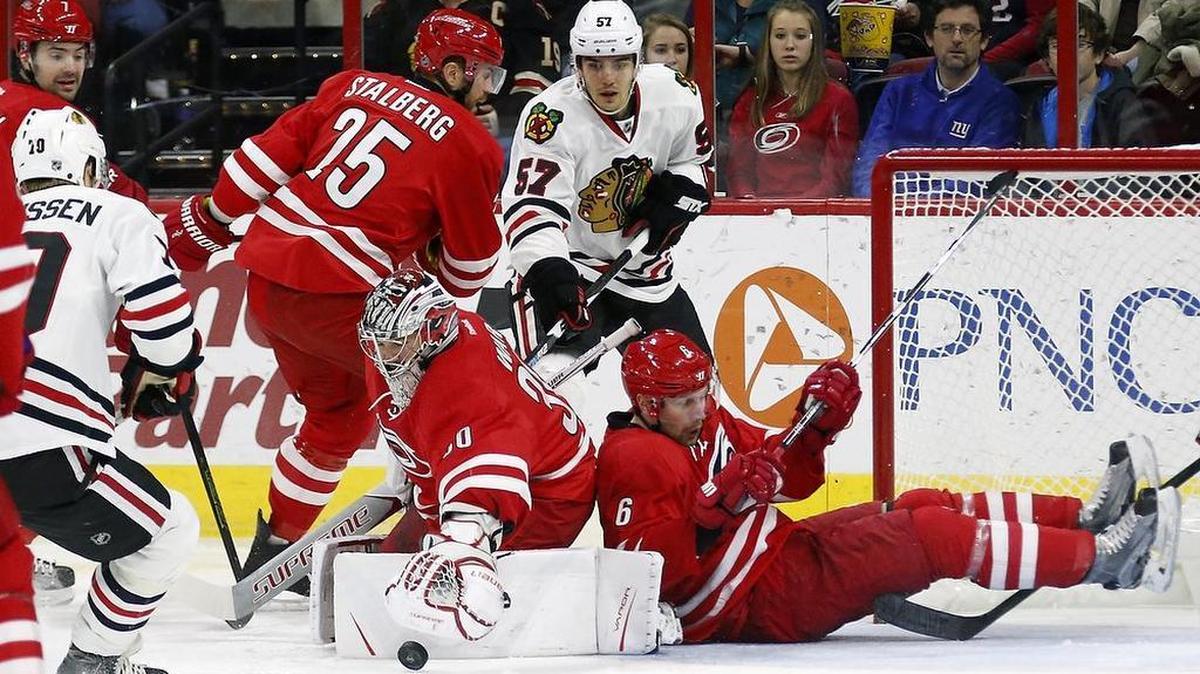 The Canes' Viktor Stalberg (25), Cam Ward (30) and Klas Dahlbeck (6) defend the net against the Chicago Blackhawks' Dennis Rasmussen (70) and Trevor van Riemsdyk (57) during the second period of an NHL game played between the Carolina Hurricanes and the Chicago Blackhawks at PNC Arena in Raleigh, N.C. on Dec. 30, 2016.