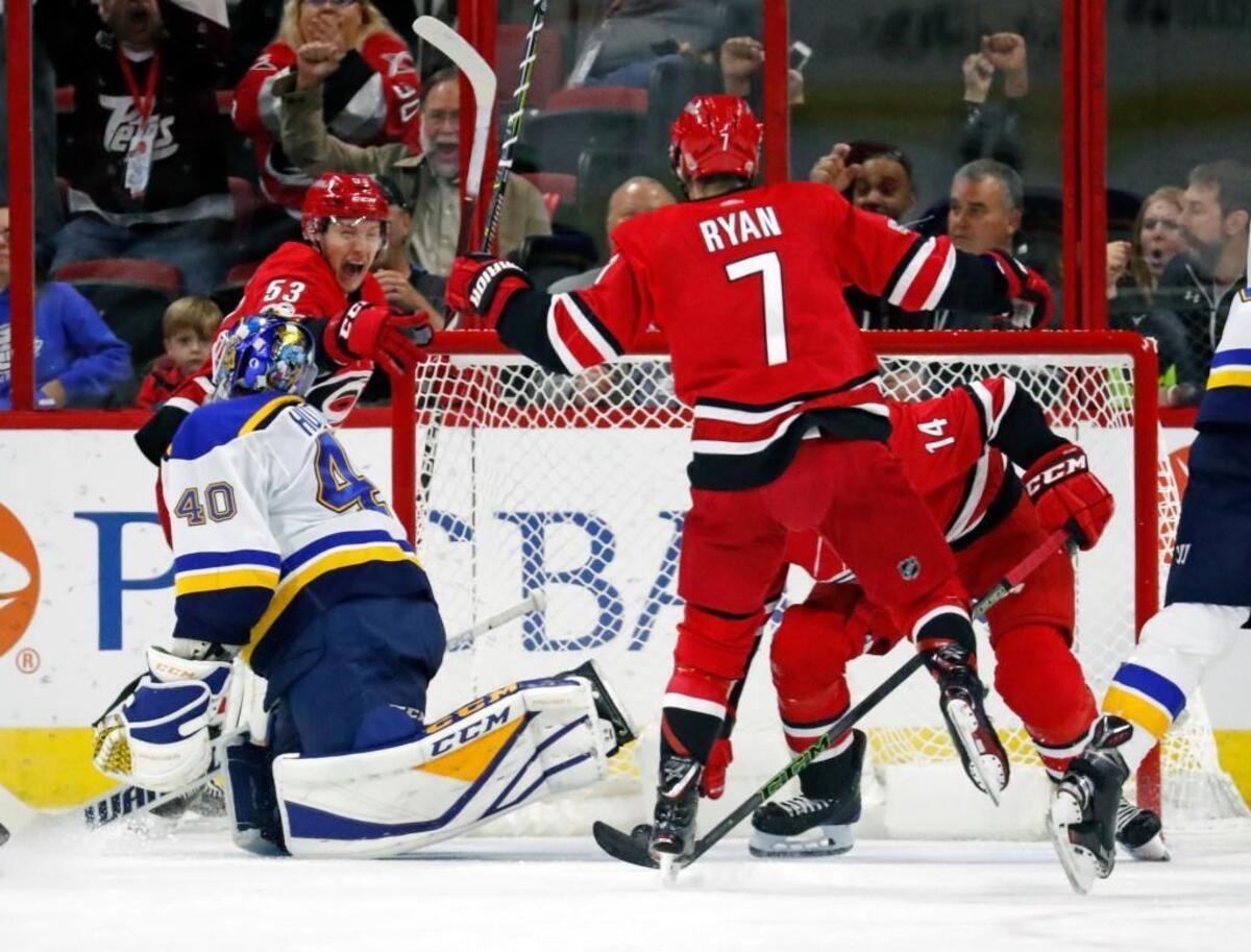 The Canes' Jeff Skinner (53) celebrates his goal with Derek Ryan (7) and Justin Williams (14) after he scored against the Blues' Carter Hutton (40) during the second period.
