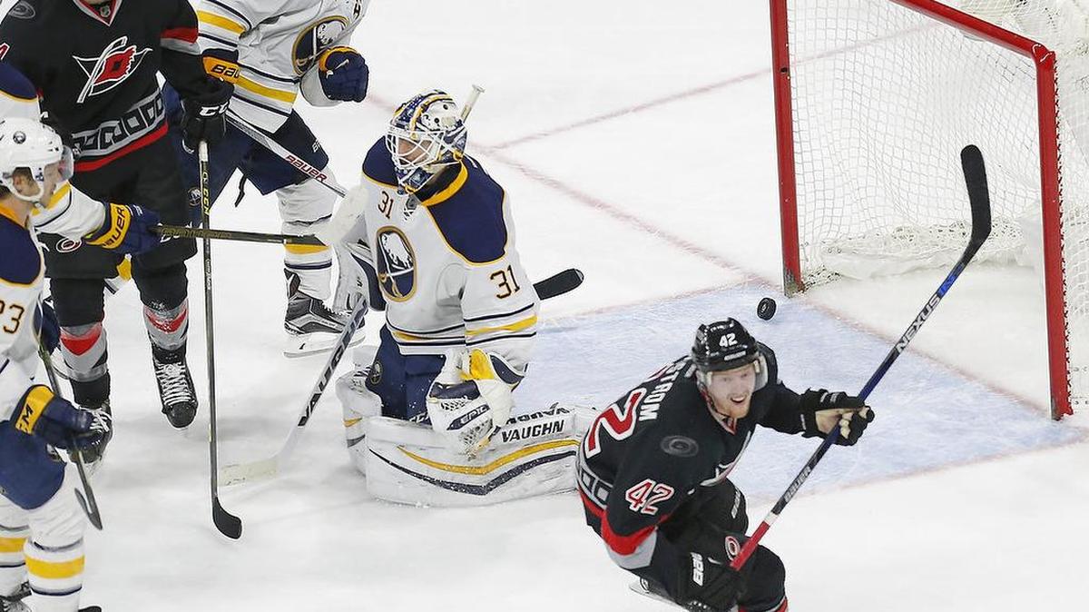 The Canes Joakim Nordstrom (42) celebrates his goal with Brett Pesce (54) after he scored against the Buffalo Sabres' Sam Reinhart (23), Josh Gorges (4) and Chad Johnson (31) during the third period.
