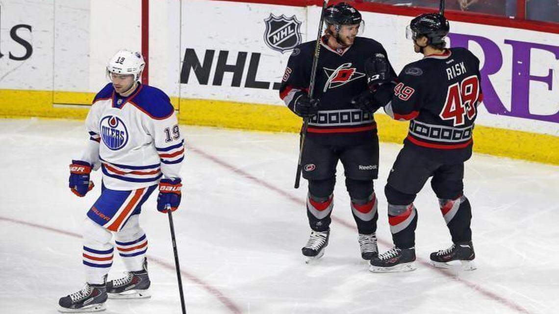 
Carolina Hurricanes' Elias Lindholm (16) of Sweden, celebrates his goal with teammate Victor Rask (49) as Edmonton Oilers' Justin Schultz (19) skates past during the third period at PNC Arena in Raleigh,. 

