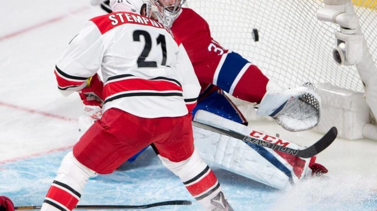 Carolina Hurricanes right wing Lee Stempniak (21) scores against Montreal Canadiens goalie Carey Price (31) during the third period on March 23, 2017, in Montreal. (Ryan Remiorz/The Canadian Press via AP)