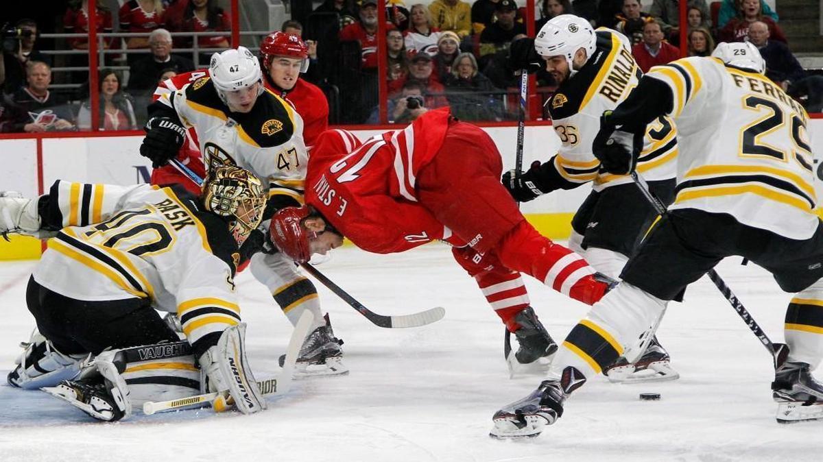 The Carolina Hurricanes' Eric Staal (12) battles against the Boston Bruins' Tuukka Rask (40), Torey Krug (47), Zac Rinaldo (36) and Landon Ferraro (29) during the first period at PNC Arena in Raleigh.
