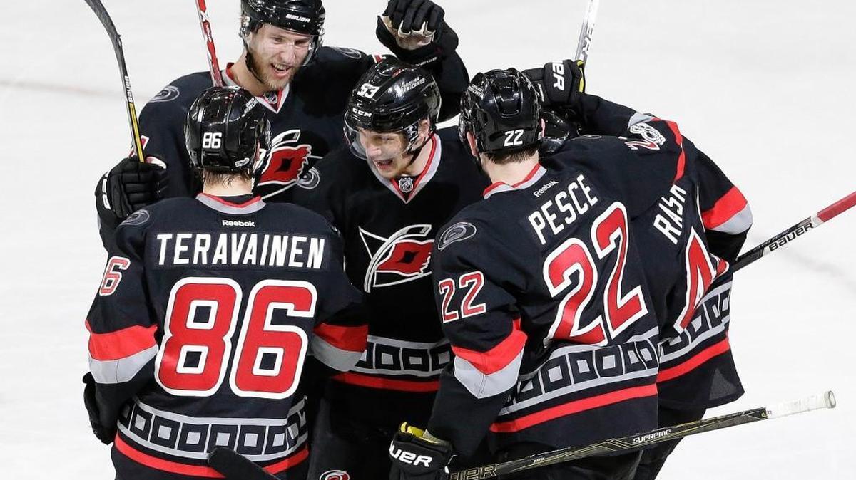 Carolina Hurricanes' Jeff Skinner, center, is congratulated by Teuvo Teravainen (86), of Finland; Brett Pesce (22); Victor Rask, right, of Sweden; and Jaccob Slavin (74) following Skinner's goal against the Columbus Blue Jackets' during the third period of an NHL hockey game in Raleigh, N.C., Thursday, March 30, 2017. Carolina won 2-1 in overtime.
