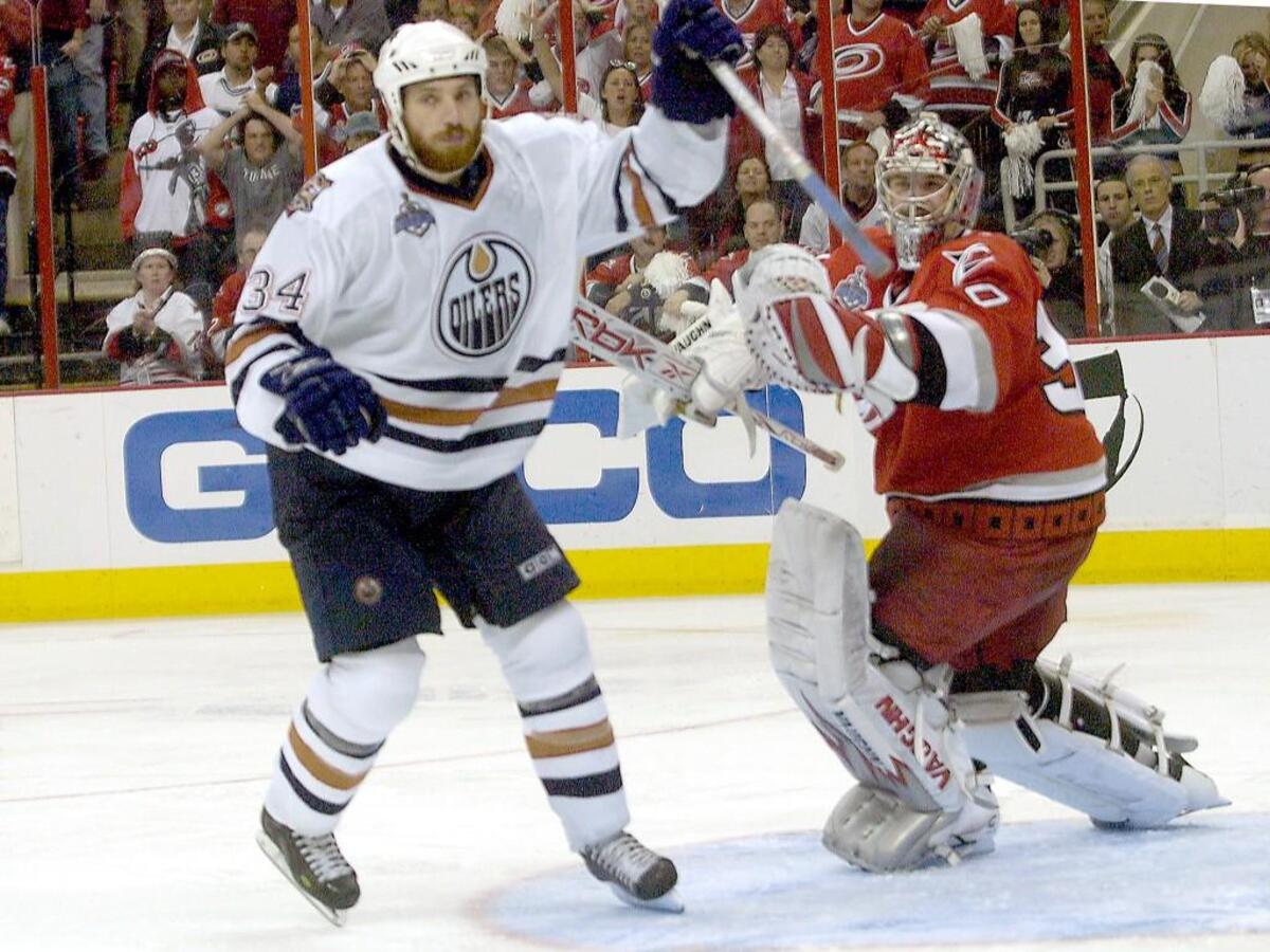 Edmonton’s Fernando Pisani (34) celebrates after he fired the game winning shot past the Canes Cam Ward (30) in overtime of Game 5 of the Stanley Cup Finals played between the Carolina Hurricanes and the Edmonton Oilers at the RBC Center. 6/14/06. The Canes lost 4-3 in overtime, making the series 3-2 in favor of the Canes.