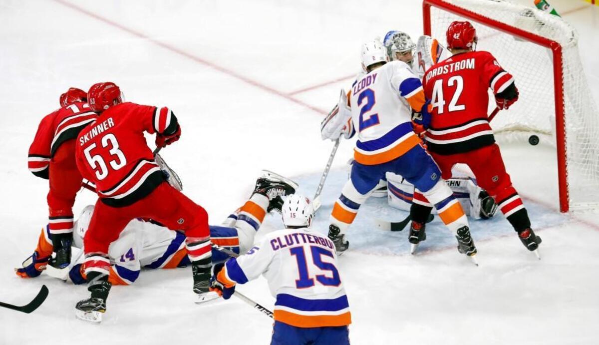 The Canes' Jeff Skinner (53) puts the puck past the Islanders' Cal Clutterbuck (15), Nick Leddy (2) and Thomas Greiss (1) for what appears to be a goal during the third period of an NHL game played between the Carolina Hurricanes and the New York Islanders at PNC Arena in Raleigh, N.C. on Feb. 16, 2018. The goal was overturned when the Islanders challenged and won, saying the play was offsides. The Islanders beat the Canes 3-0.