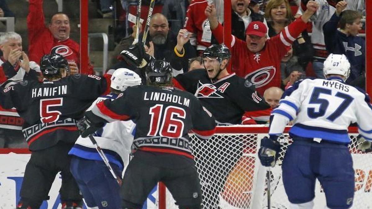 The Carolina Hurricanes' Jordan Staal (11) celebrates his goal with Noah Hanifin and Elias Lindholm after he scored against the Winnipeg Jets' Tyler Myers (57) and goalie Ondrej Pavelec during the first period at the PNC Arena in Raleigh.