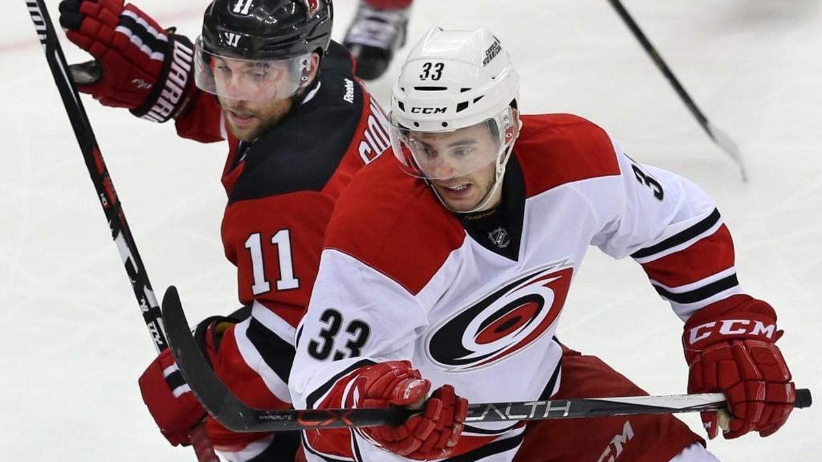 Carolina Hurricanes center Derek Ryan (33) collides with New Jersey Devils center Stephen Gionta (11) during the third period of an NHL hockey game Tuesday, March 1, 2016, in Newark, N.J. Hurricanes won 3-1. (AP Photo/Mel Evans)