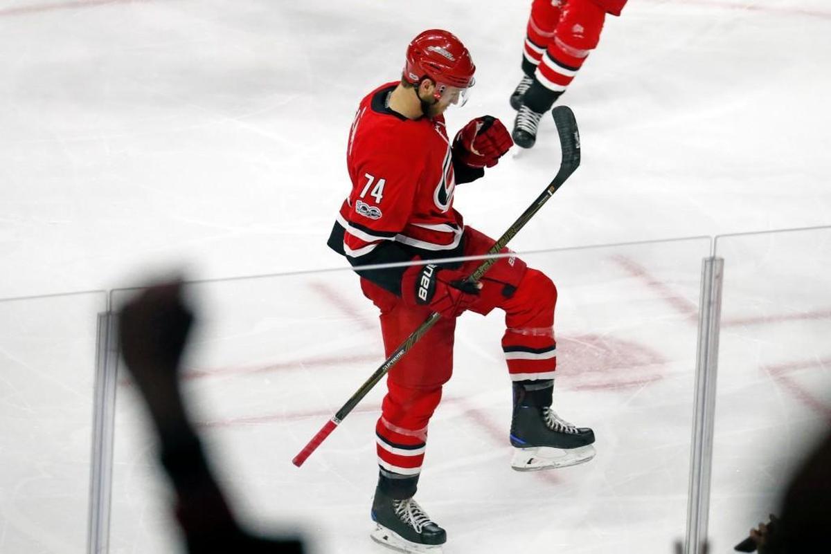 The Canes' Jaccob Slavin (74) celebrates after he scored against the Lightning during the third period.