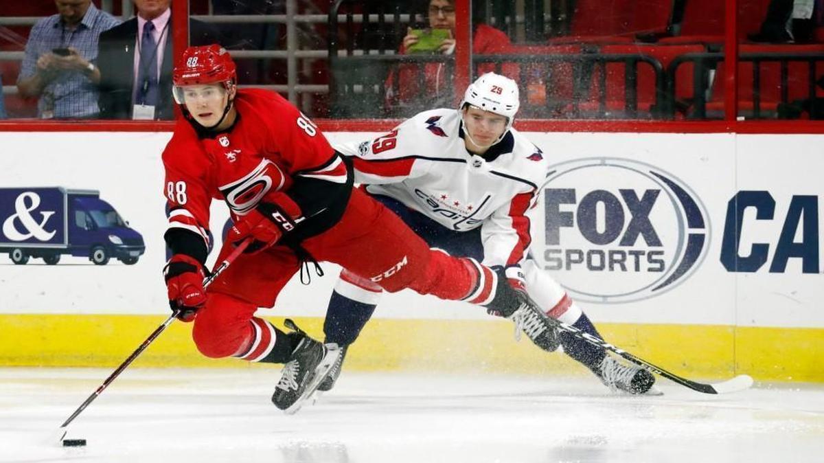 The Canes' Martin Necas (88) battles the Caps' Madison Bowey (22) for the puck during the second period of a preseason NHL game played between the Carolina Hurricanes and the Washington Capitals at PNC Arena on Friday, Sept. 29, 2017.