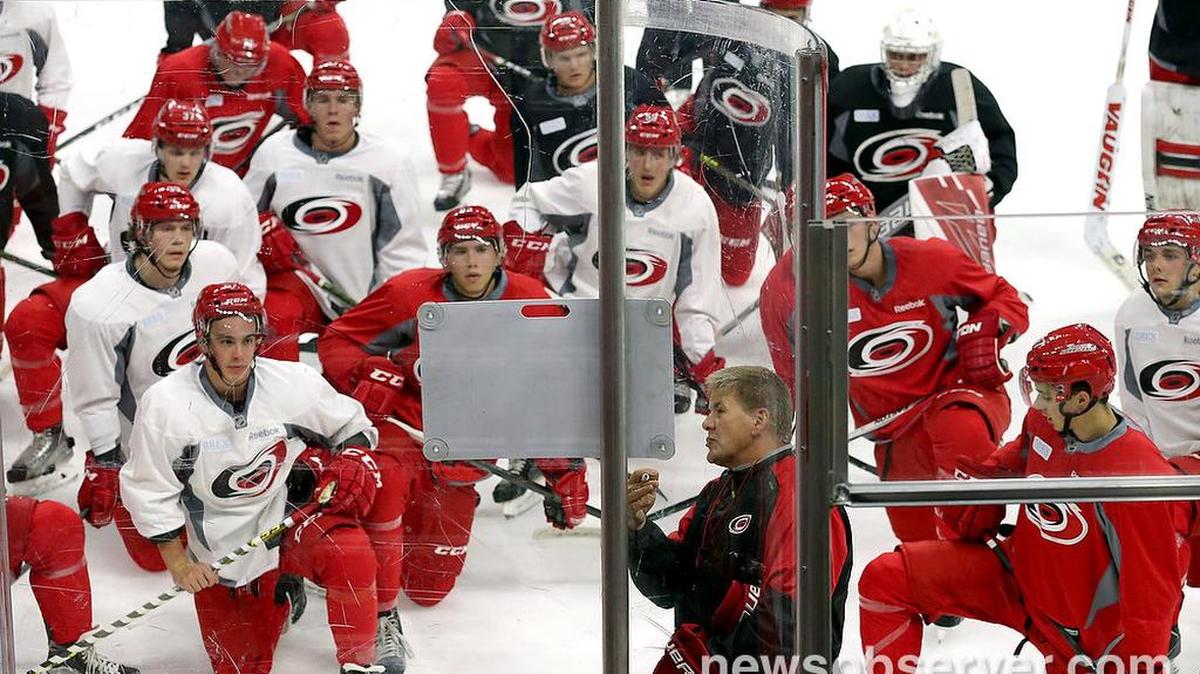 Head coach Bill Peters diagrams a drill for the players.